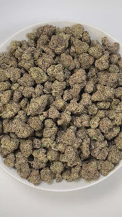 PUFFY Amarena de Limon is a sativa-dominant hybrid THCa strain, born from the legendary cross between Gelato 41 × ZKZ. The aroma bursts with sharp gassy notes, zesty lemon brightness, and a pungent chemical edge for a bold, unforgettable profile. Visually, the buds appear thick and rounded, showcasing dark green tones with flashes of purple, blanketed in shimmering trichomes and highlighted by vibrant orange pistils. Consumers often describe it as delivering a lively, mood-brightening high that boosts creat