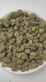 PUFFY Punch Drunk is an indica-dominant hybrid THCa strain, created from the fusion of Purple Punch and Headstash. The aroma delights the senses with a juicy fusion of fresh watermelon, sweet candy, and a splash of fruity punch for an irresistibly playful scent. Visually, the buds captivate with dense, showcasing deep green and royal purple tones intertwined with bright orange pistils and a shimmering coat of trichomes. Consumers often report a euphoric head buzz that uplifts mood and sparks sociable energy