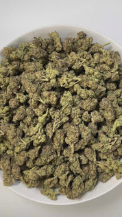 PUFFY Lemon Candy is a sativa-dominant hybrid THCa strain, crafted from the legendary lineage of American indica with NYC Diesel. The aroma carries strong notes of eucalyptus, layered with sharp hints of gas and a distinct chemical undertone. Visually striking, these dense, frosty buds glisten with trichomes, displaying deep greens with hints of lime and purple, accented by vibrant orange pistils. Consumers often report an initial wave of uplifting euphoria that elevates the spirit and energizes the mind, g