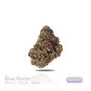 PUFFY Blue Runtz  is an indica-dominant hybrid THCa strain, born from the renowned pairing of Blueberry and White Runtz. The aroma opens with luscious ripe cherry notes, beautifully layered with delicate floral undertones and a smooth, candy-like sweetness that creates an inviting and elegant sensory experience. Visually, dense green buds with purple accents and fiery orange pistils are coated in sticky, glistening trichomes. Consumers often report a balanced experience of uplifting euphoria and mental clar