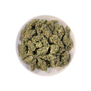 PUFFY GMO is a potent indica-dominant hybrid THCa strain, born from the legendary cross of Girl Scout Cookies and Chemdawg. The aroma opens with pungent onion notes, layered with fresh herbal undertones and crisp hints of pine. Visually, the buds are dense and sticky, showcasing a striking mix of dark green and purple hues, drenched in thick crystalline trichomes and accented by fiery orange pistils. Consumers often report a deeply relaxing and calming effect that begins with a euphoric lift, then gradually