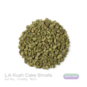 PUFFY LA Kush Cake (smalls) is an indica-dominant hybrid THCa strain, created from the legendary pairing of LA Confidential and Wedding Cake. The aroma opens with rich earthy notes, smoothly layered with a creamy softness and finished by a refreshing hint of mint. Visually, dense green buds shimmer with resin, highlighted by orange pistils and frosty trichomes. Consumers often report a soothing body relaxation, uplifted mood, gentle mental clarity, and a noticeable boost in appetite.