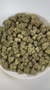 PUFFY Cherry Cookies is an indica-dominant hybrid THCa strain, created by crossing Cherry Pie and Girl Scout Cookies (GSC). The aroma combines the sweet scent of ripe cherries with a rich creamy layer and a sharp gassy kick. Visually, the buds are tightly packed and resinous, showcasing deep green tones with vibrant orange pistils and occasional hints of purple. Consumers often report a balanced experience that begins with happiness, euphoria, and mental clarity, eventually easing into soothing physical rel