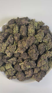 PUFFY Black Truffle is a premium indica-dominant hybrid THCa strain, born from the flavorful cross of Gelato 33 and Chocolate Kush. The aroma is a rich blend of earthy, sweet, and woody notes, with a deep musky undertone that lingers beautifully. Visually, the dense buds range from dark green to deep purple, coated in a thick layer of frosty trichomes and highlighted by bright orange hairs. Consumers often report a euphoric, uplifting mental buzz followed by deep body relaxation and a calming effect, making