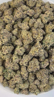 PUFFY Drippin Ain’t Eazy is a hybrid THCa strain, a lively and flavorful cross between Drip Station and Gary Poppins. A rich and complex aroma featuring bold diesel notes, layered with musky undertones, complemented by hints of ripe fruitiness, creamy smoothness, and a subtle, lingering sweetness. Visually, dense buds glisten with frosty trichomes, showcasing deep purple and pale green hues. Consumers often describe it as delivering a balanced experience that soothes and relaxes while stimulating creativity