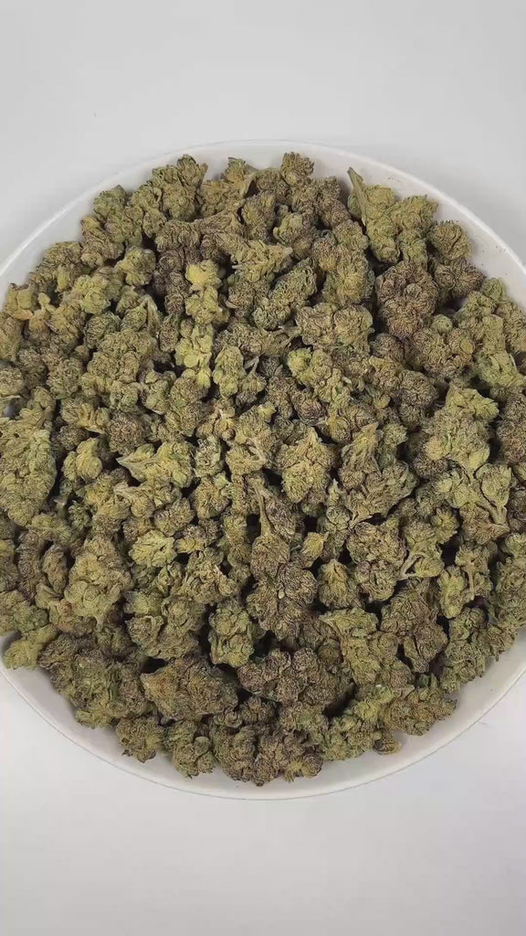 PUFFY Russian Assassin is an indica-dominant hybrid THCa strain, expertly crafted from the renowned genetics of Skywalker, Lemon OG Kush, and Headband. The aroma is a complex blend of herbal notes, pungent gassy undertones, and delicate floral hints, creating a distinctive and intriguing scent profile. Visually, dense green buds with purple hues and fiery orange pistils are coated in sticky trichomes. Consumers often report euphoric and happy feelings, cerebral stimulation that transitions into deep relaxat