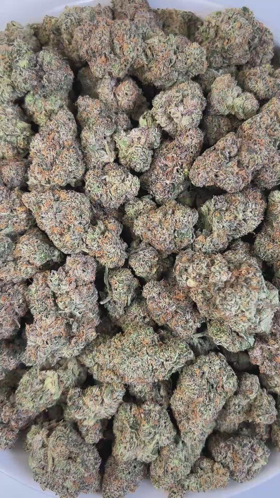 PUFFY Gwala is a balanced hybrid THCa strain created by crossing Rainbow Beltz and Moonbow. Aroma is a luscious mix of sweet tropical notes layered with ripe, juicy fruit.  Visually, dense buds draw the eye with vivid greens, deep purples, and fiery oranges, all wrapped in a sparkling blanket of resinous trichomes. Consumers often experience a balanced high that lifts the mood with euphoria and mental clarity before easing into calming physical relaxation, offering stress relief without sacrificing focus or