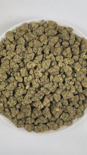 PUFFY Sour OG is a balanced hybrid THCa strain, born from the cross of Sour Diesel and OG Kush. The aroma is a bold blend of chemical undertones, pungent diesel, and a distinctly gassy note. Visually striking, these dense buds feature deep green tones with purple accents, dotted with orange pistils and a sparkling trichome coating. Consumers often report an initial euphoric head high that gradually flows into a soothing, relaxed body sensation, leaving them feeling blissful, sociable, and energized. 