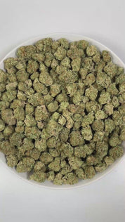 PUFFY Papaya Punch is an indica-dominant hybrid THCa strain crafted from the flavorful union of Papaya and Purple Punch. The aroma is zesty and lively, layered with sweet tropical fruit notes and a delicate floral undertone that creates a bright, inviting fragrance. Visually, the buds are dense and heart-shaped, showcasing a vibrant forest green color accented by fiery orange hairs and a thick, frosty coating of milky amber trichomes. Consumers often report a smooth high, beginning with a gentle cerebral up