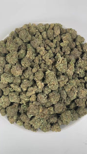 PUFFY Bubba Kush is an indica-dominant hybrid THCa strain, crafted from the legendary lineage of OG Kush × Afghani Indica. An enticing aroma of freshly brewed coffee, intertwined with subtle herbal tones, and softened by a smooth, creamy warmth. Visually striking, the buds are dense and resin-packed, shimmering with frosty trichomes over deep green and purple hues accented by bright orange hairs. Consumers often describe the effects as a wave of full-body relaxation that eases stress and pain, encourages re