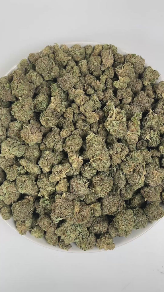 PUFFY Bubba Kush is an indica-dominant hybrid THCa strain, crafted from the legendary lineage of OG Kush × Afghani Indica. An enticing aroma of freshly brewed coffee, intertwined with subtle herbal tones, and softened by a smooth, creamy warmth. Visually striking, the buds are dense and resin-packed, shimmering with frosty trichomes over deep green and purple hues accented by bright orange hairs. Consumers often describe the effects as a wave of full-body relaxation that eases stress and pain, encourages re