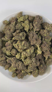 PUFFY Purple Glue is an indica-dominant hybrid THCa strain, crafted from the legendary cross of Purple Kush and Gorilla Glue #4 (GG4). The aroma is rich and inviting, combining smooth creamy notes with a warm, buttery finish for a decadent profile. Visually, the buds are dense and resinous with green and purple tones, bright orange pistils, and a frosty trichome finish. Consumers describe a high that opens with a burst of euphoria and mental lift before melting into a soothing full-body calm, making it a fa