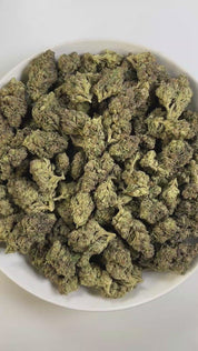 PUFFY Ice Cream Cake is an Indica-dominant hybrid THCa strain, born from the potent cross between Wedding Cake and Gelato #33. The aroma blends delicate floral notes with creamy buttery undertones and a subtle hint of sweet fruit, creating a soft and inviting fragrance. Visually, its buds are dense and chunky, showcasing a vibrant mix of green and purple hues with occasional touches of lavender, accented by fiery orange pistils. Consumers often report an experience that begins with a euphoric, uplifting cer