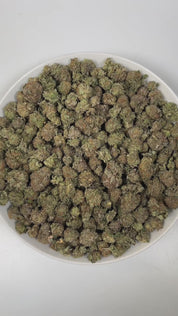 PUFFY Hubba Bubba is an indica-dominant hybrid THCa strain, born from the masterful cross between Fudo and Bubba Kush. The aroma is boldly skunky and pungent, layered with sharp, lingering notes that are beautifully balanced by a subtle yet noticeable floral sweetness. Visually, dense spring-green buds with purple hues and fiery orange pistils are coated in sticky trichomes. Consumers often report a happy, euphoric, and uplifting high that gradually settles into a soothing sense of physical relaxation, crea