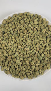 PUFFY Papaya Punch (smalls) is an indica-dominant hybrid THCa strain crafted from the flavorful union of Papaya and Purple Punch. The aroma is a vibrant blend of papaya and tropical fruits, underscored by a subtle, yeasty note that adds depth and complexity. Visually, the buds are dense and heart-shaped, showcasing a vibrant forest green color accented by fiery orange hairs and a thick, frosty coating of milky amber trichomes. Consumers often report a smooth high, beginning with a gentle cerebral uplift tha