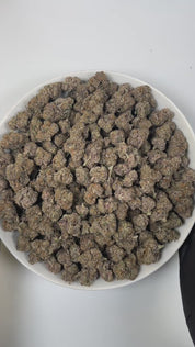 PUFFY Original Z is an indica-dominant hybrid THCa strain, carefully crafted by blending the celebrated genetics of Grape Ape and Grapefruit with a secret third strain. The aroma delights the senses with sweet, candy-like notes, juicy tropical fruit undertones, and bright, zesty accents that create a lively and playful scent. Visually, the dense buds display bright green hues with hints of purple, highlighted by vibrant orange pistils and a thick, frosty coating of trichomes.
