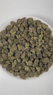 PUFFY Velato is a balanced hybrid THCa strain, originating from the fusion of Gelato 41 and ZKZ. The aroma is a bold and intense blend, featuring pungent notes with hints of tar and the sharp, unmistakable scent of gasoline. Visually, the buds are compact and frosty, showcasing green and purple hues with bright orange pistils and a thick coating of sparkling trichomes. Consumers often report feeling deeply relaxed, uplifted with a sense of happiness, and wrapped in a warm wave of euphoric bliss that gently 