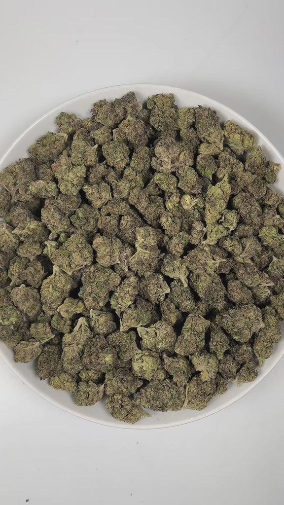 PUFFY Velato is a balanced hybrid THCa strain, originating from the fusion of Gelato 41 and ZKZ. The aroma is a bold and intense blend, featuring pungent notes with hints of tar and the sharp, unmistakable scent of gasoline. Visually, the buds are compact and frosty, showcasing green and purple hues with bright orange pistils and a thick coating of sparkling trichomes. Consumers often report feeling deeply relaxed, uplifted with a sense of happiness, and wrapped in a warm wave of euphoric bliss that gently 