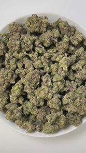 PUFFY Blueberry Jam is an indica-dominant hybrid THCa strain, born from the legendary cross between Blueberry and Northern Lights. The aroma unfolds with sweet blueberries, sharp diesel undertones, and a refreshing hint of mint, creating a bold and intriguing scent profile. Visually, dense, chunky buds showcase forest green and golden tones, highlighted by orange pistils and deep blue hints, all dusted with sparkling trichomes. Consumers often describe a harmonious high that starts with a bright, uplifting 