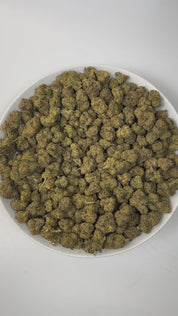 PUFFY Black Runtz is an indica-dominant hybrid THCa strain, born from the renowned cross of ZKZ and Gelato. The aroma bursts with zesty citrus notes, grounded by earthy undertones and a hint of gassy intensity, creating a scent that’s both vibrant and unforgettable. Visually, dense green buds with purple hues and fiery orange pistils are coated in sticky trichomes. Consumers often report an initial wave of uplifting euphoria, creativity, and happiness that gradually transitions into deep relaxation and calm