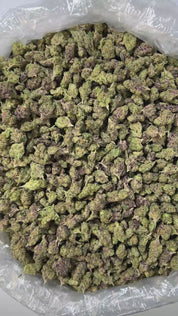 PUFFY Rocket Fuel (smalls) is an indica-dominant THCa strain, bred from a powerhouse cross of Jet Fuel OG and Face Off OG BX1. The aroma profile is distinctly earthy and gassy, with strong chemical undertones that amplify its pungency and depth. Visually, the buds are dense and compact, with a rich forest green base accented by subtle purple hues, vibrant orange pistils, and a thick layer of sparkling white crystalline trichomes. Consumers frequently describe experiencing a euphoric boost, uplifting energy,