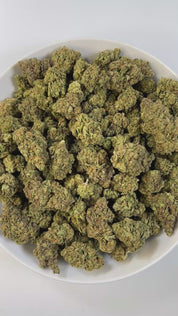 PUFFY White Truffle is an indica-dominant hybrid THCa strain, crafted from the legendary lineage of Gorilla Butter, a standout phenotype of Gorilla Glue #4 × Peanut Butter Breath. The aroma carries earthy undertones, blended with a doughy richness and subtle herbal notes. Visually striking, these medium-sized buds glisten under a thick frost of white trichomes, with vibrant orange pistils winding through deep green and purple tones. Consumers often report a wave of euphoria that lifts mood and sharpens focu