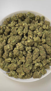 PUFFY Biscotti is an indica-dominant hybrid THCa strain born from the flavorful cross of Gelato #25 and South Florida OG. The aroma blends sweet notes of honey and caramel with a sharp, gassy undertone. Visually, the buds are compact and rock-like with rich green to dark jade tones, occasional violet streaks, fiery orange pistils, and a sparkling resin coating that gives them a candied appearance. Consumers often report the high as a balanced experience that starts with a cerebral uplift, sparking creativit