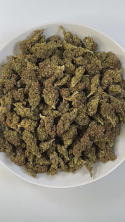 PUFFY Peach Ringz is an indica-dominant hybrid THCa strain born from the flavorful cross of Marionberry and Eddy OG. The aroma is a delightful blend of sweet, juicy peaches, subtle candied sugar, and the soft, sun-ripened essence of apricots. Visually, the buds are bushy and densely packed, covered in glistening trichomes with minty  green tones and dark olive undertones. Consumers frequently describe this strain as offering a harmonious experience, starting with a light, uplifting mental clarity that brigh