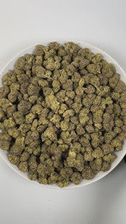 PUFFY Warhead is a sativa-dominant  hybrid THCa strain, expertly crafted from a potent cross between Kaboom and Sour Pez. The aroma opens with a tangy, zesty burst, delivering a sharp sourness that instantly awakens the senses. Visually, the dense forest-green buds are accented by rich purple hues and fiery orange pistils, all generously coated in a thick layer of sticky, glistening trichomes. Consumers often report uplifting, energizing, and euphoric effects with a strong cerebral lift that enhances focus,