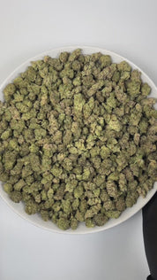 PUFFY Ice Cream Cake (smalls) is an Indica-dominant hybrid THCa strain, born from the potent cross between Wedding Cake and Gelato #33. The aroma unfolds with a rich, creamy sweetness, layered with warm vanilla notes and delicate floral undertones. Visually, its buds are dense and chunky, showcasing a vibrant mix of green and purple hues with occasional touches of lavender, accented by fiery orange pistils. Consumers often report an experience that begins with a euphoric, uplifting cerebral high, gradually 