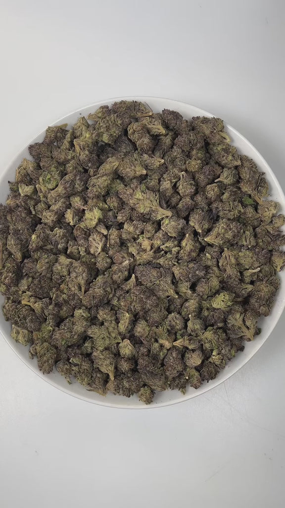 PUFFY Purple Candy is an indica-dominant hybrid THCa strain, expertly crafted from a premium cross of BC Sweet Tooth and Mendocino Purps. The aroma bursts with sweet grape and candy notes, grounded by a rich, earthy undertone that captivates the senses. Visually, dense green buds with purple hues and fiery orange pistils are coated in sticky trichomes. Consumers often report a deep sense of relaxation and calm, paired with happiness and euphoria, a soothing body buzz, and a noticeable boost in appetite.
