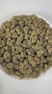 PUFFY Pink Certz is a balanced hybrid THCa strain, created from the potent pairing of The Menthol and Grape Gasoline. The aroma is a bold blend of sweet candy notes, sharp gassy undertones, and pungent chemical hints, creating a striking and memorable scent profile. Visually, dense frosty buds glow neon green with golden hints and pink-orange hairs, coated in sparkling, gem-like trichomes. Consumers often experience an uplifting, clear-headed euphoria that sparks creativity and focus, followed by gentle bod