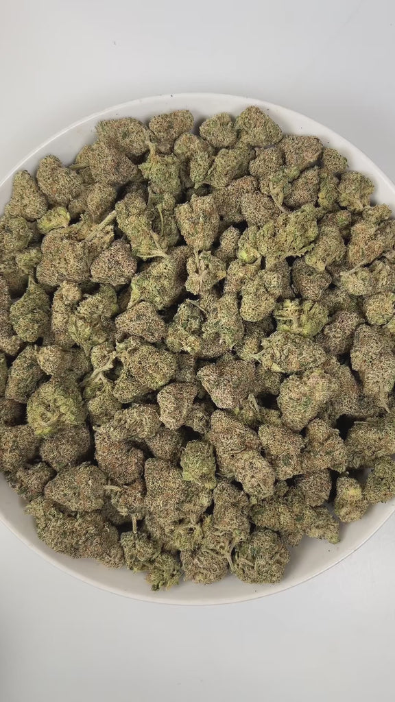 PUFFY Pink Certz is a balanced hybrid THCa strain, created from the potent pairing of The Menthol and Grape Gasoline. The aroma is a bold blend of sweet candy notes, sharp gassy undertones, and pungent chemical hints, creating a striking and memorable scent profile. Visually, dense frosty buds glow neon green with golden hints and pink-orange hairs, coated in sparkling, gem-like trichomes. Consumers often experience an uplifting, clear-headed euphoria that sparks creativity and focus, followed by gentle bod