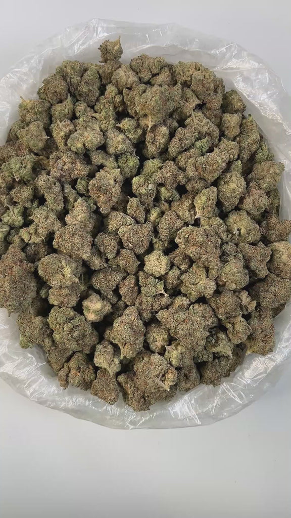 PUFFY Chem OG is a balanced premium hybrid THCa strain born from the iconic cross between Chemdawg and OG Kush. The aroma is unmistakably pungent, an intense fusion of sharp chemical notes, savory garlic, and a deep, stinky funk that hits hard and lingers in the air. Visually striking, its dense buds feature dark green leaves accented by vibrant orange pistils and a heavy coating of frosty trichomes. Consumers often report a wave of uplifting happiness that gradually melts into deep, soothing sedation makin