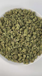 PUFFY Burger Breath (smalls) is an indica-dominant hybrid THCa strain, bred from the renowned cross of GMO Cookies and Larry OG F8. The aroma combines deep earthy notes with a sharp gassy punch, creating a bold and grounding profile. Visually, the buds are compact and resinous, with rich green hues, bright orange pistils, and a frosty trichome finish that may show hints of purple. Consumers describe a high that starts with an uplifting wave of euphoria and light creativity before melting into deep physical 