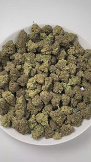 PUFFY Papaya is a premium hybrid THCa strain, created from a cross between Citral #13 and Ice #2. The aroma bursts with tropical vibrance, blending juicy apricot sweetness and refreshing melon undertones for a lush, island-inspired scent. Visually, this strain showcases dense, compact buds in shades of bright to deep lime green, heavily coated in white, milky trichomes that give it a frosty appearance. Consumers often describe the effects as euphoric and uplifting, with a gentle cerebral buzz that enhances 