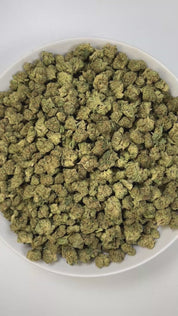 PUFFY Wedding Cake (smalls) is an indica-dominant hybrid THCa strain created by crossing Triangle Cherry Pie and Girl Scout Cookies (GSC). The aroma is a captivating mix of pungent gas, layered with sweet undertones and delicate floral accents for a balanced yet striking profile. Visually, the buds are dense and vibrant, with forest green and purple hues coated in frosty trichomes and bright orange pistils. Consumers often report a euphoric, uplifted mood paired with a relaxing body high, along with a creat