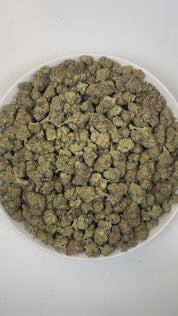 PUFFY Double Kush Cake is an indica-dominant hybrid THCa strain, born from a powerful cross between Hindu Kush, Afghani #1, and Skunk Kush. The aroma opens with rich, earthy notes of woody cedar, layered with a deep, musky undertone that lingers enticingly. Visually, dense green buds with purple hues and fiery orange pistils are coated in sticky trichomes. Consumers often report a deeply relaxing, full-body effect, accompanied by a gentle uplift in mood, providing soothing relief from anxiety, stress, occas