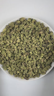 PUFFY Gush Mintz (smalls) is an indica-dominant hybrid THCa strain, born from the cross of Kush Mints × (F1 Durb × Gushers). The aroma greets the senses with a sharp minty freshness, rich cheesy notes, and a bold, pungent undertone. Visually, the buds are dense and striking, showcasing dark green and deep purple hues intertwined with vibrant orange pistils and a sparkling layer of shimmering trichomes. Consumers often describe a powerful, body-zapping high that dissolves stress and tension, leaving the mind