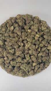 PUFFY Blue Nerdz is a balanced hybrid THCa strain, born from the fusion of Forbidden Fruit and Watermelon Z. The aroma bursts with sweet candy notes intertwined with ripe berries and a fresh piney finish, offering a delightful blend of fruity and forest-like scents. Visually, it features compact, bulbous buds in green and deep purple hues, highlighted by orange pistils and a thick frost of trichomes. Consumers often report an initial cerebral uplift characterized by euphoria, elevated mood, and a burst of c