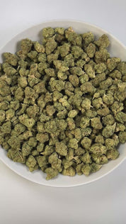 PUFFY Wedding Cake is an indica-dominant hybrid THCa strain created by crossing Triangle Cherry Pie and Girl Scout Cookies (GSC). The aroma is a balanced blend of earthy richness, sweet undertones, and delicate floral notes. Visually, the buds are dense and vibrant, with forest green and purple hues coated in frosty trichomes and bright orange pistils. Consumers often report a euphoric, uplifted mood paired with a relaxing body high, along with a creative and social spark in lighter use.
