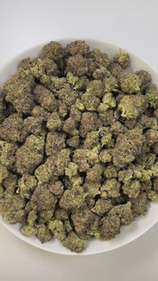 PUFFY Lava Cake is an indica-dominant hybrid THCa strain, crafted from the legendary lineage of Cross of Thin Mint × Grape Pie. The aroma is rich and inviting, with creamy, buttery notes that give off a sweet, dessert-like essence. Visually, the buds are dense with purple highlights, vibrant greens, and bright orange hairs, all dusted in frosty trichomes. Consumers often describe an initial wave of cerebral euphoria and light uplift before the experience shifts into deep physical calm.
