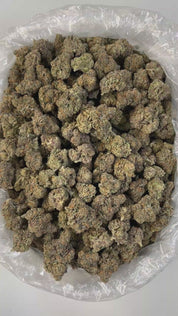PUFFY Banana Jealousy is an indica-dominant hybrid THCa strain, the result of a flavorful cross between Banana Cream Cake and Jealousy. Its aroma is a rich, grounding blend of earthy undertones, enhanced by warm woody notes and a distinct touch of aromatic cedar. Visually, the buds are dense and resin-coated, showcasing a vibrant mix of forest green and lime hues, highlighted by thin orange pistils and a generous dusting of frosty trichomes. Consumers often report a euphoric, happy, and focused head hi