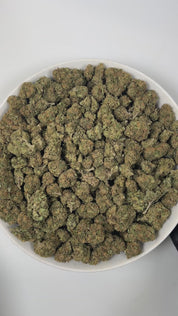 PUFFY Baby Jokerz is an indica-dominant hybrid THCa strain, created from the legendary pairing of White Runtz and Jet Fuel Gelato. The aroma is a delightful blend of sweet grape, delicate floral notes, and subtle herbal undertones, creating a fragrant and inviting scent. Visually, the buds are dense and rich in color, showcasing deep green and purple hues, vibrant orange pistils, and a generous coating of glistening trichomes. Consumers often report an initial euphoria, heightened focus, and an uplifted moo