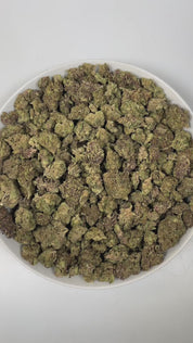 PUFFY Fruity Pebbles is an indica-dominant hybrid THCa strain, born from the intricate cross of Green Ribbon × Granddaddy Purple x Tahoe Alien. The aroma of this strain is a captivating blend of fruity sweetness, subtle licorice notes, and warm, aromatic spices, creating a complex and inviting scent profile that entices the senses. Visually, dense green buds with purple hues and fiery orange pistils are coated in sticky trichomes. Consumers often report a blissful blend of happiness and euphoria, feeling up