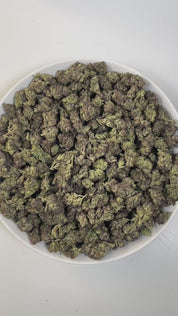 PUFFY Glazed Donut is a balanced hybrid THCa strain, born from the flavorful fusion of Grape Slushie and Purple Punch. The aroma opens with sweet, sugary notes, followed by a smooth creamy richness and finished with a distinct gassy edge that adds depth and complexity. Visually, dense olive-green buds with purple accents and fiery orange pistils are coated in sticky, glistening trichomes. Consumers often report a gradual cerebral euphoria and uplifted mood, paired with deep full-body relaxation, leaving the