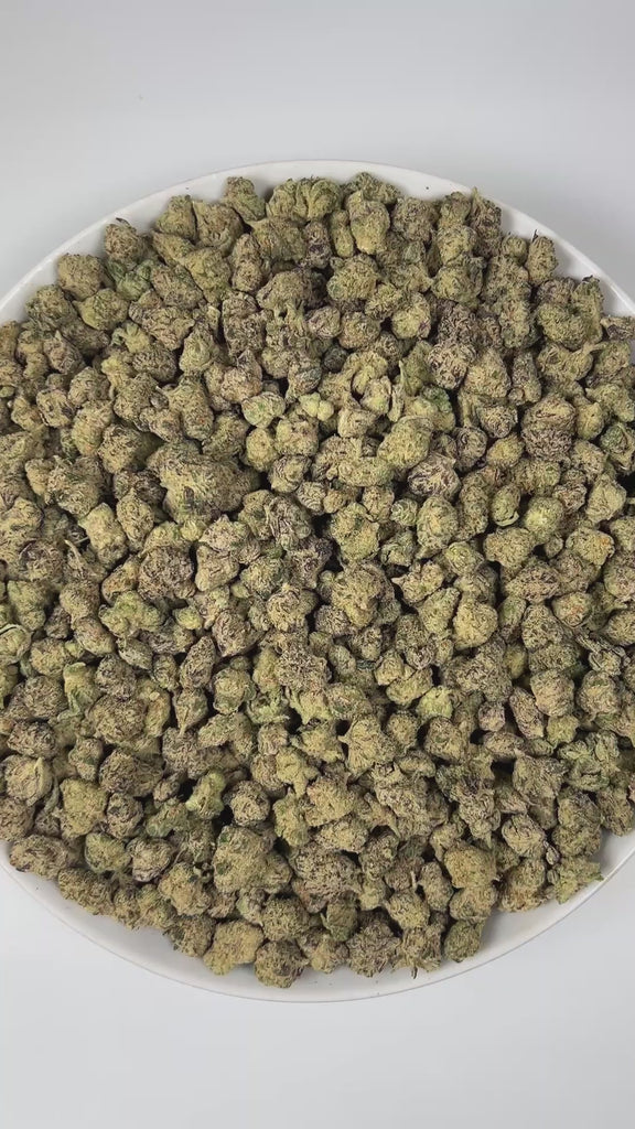 PUFFY Biscotti X Jealousy (smalls) is a balanced hybrid THCa strain, it’s a direct cross between Biscotti and Jealousy. The aroma is a captivating blend of freshly baked cookies, sweet berries, and a warm, nutty undertone that creates an irresistibly rich and comforting scent. Visually, the buds are dense and dark green with striking purple accents, adorned with vibrant orange pistils and coated in a sparkling layer of frosty trichomes. Consumers often report a balanced high, with an uplifting cerebral buzz