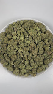 PUFFY Triangle Kush is an indica-dominant hybrid THCa strain, born from a powerful cross between Florida OG Kush and Hindu Kush. The aroma bursts with zesty lime notes, grounded by earthy undertones and a bold, pungent finish that lingers enticingly. Visually, dense deep green buds with purple hues and fiery orange pistils are coated in sticky trichomes. Consumers frequently describe effects that begin with a calming body sensation that helps ease stress and anxiety, followed by an uplifting cerebral high t