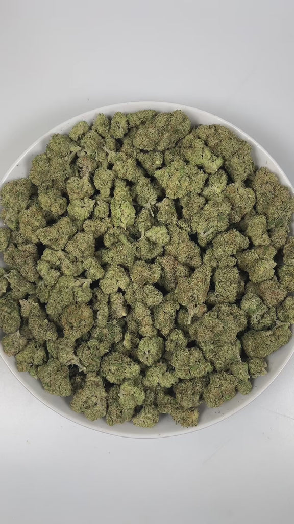 PUFFY Triangle Kush is an indica-dominant hybrid THCa strain, born from a powerful cross between Florida OG Kush and Hindu Kush. The aroma bursts with zesty lime notes, grounded by earthy undertones and a bold, pungent finish that lingers enticingly. Visually, dense deep green buds with purple hues and fiery orange pistils are coated in sticky trichomes. Consumers frequently describe effects that begin with a calming body sensation that helps ease stress and anxiety, followed by an uplifting cerebral high t