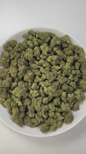 PUFFY Cartel Cut is an indica-dominant hybrid THCa strain, created by crossing Chemdog and Purple Urkle. The aroma carries a soothing blend of fresh herbal notes layered with creamy sweetness and a subtle woody finish. Visually, the buds are dense and deep green, accented with subtle purple hues, bright orange pistils, and a thick layer of frosty trichomes. Consumers often report a fast-hitting cerebral high that melts into full-body relaxation, making it popular for easing stress, lifting mood, and promoti